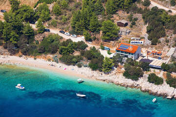Dům Dorela v sousední zátoce vedle zátoky Vela Planica - letecký pohled, ostrov Brač, Chorvatsko