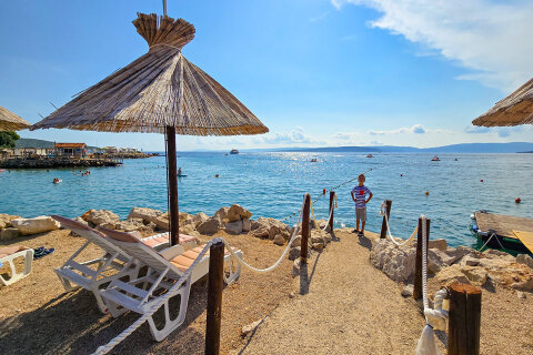 Punat - půjčovna lehátek a slunečníků u pláže, ostrov Krk, Chorvatsko