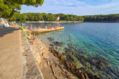 Mali Lošinj - oblázková pláž u mola Veli mul v zátoce Ostrugova, ostrov Lošinj, Chorvatsko